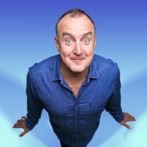 Image of Jimeoin, an Irish comedian, looking straight ahead wearing a blue shirt Image of Jimeoin, an Irish comedian, looking straight ahead wearing a blue shirt