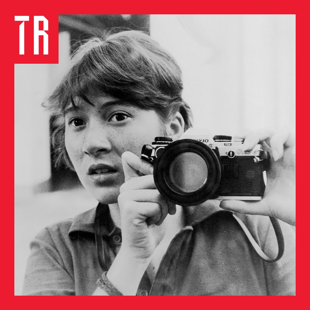 Image: Jane Hutcheon A black and white image of a young woman holding a camera up to the mirror.