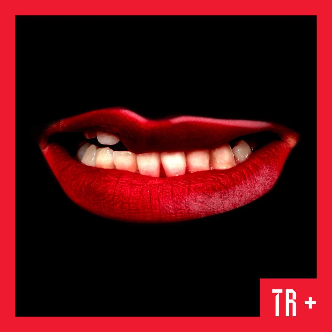 A pair of red lips with a black background float in space.