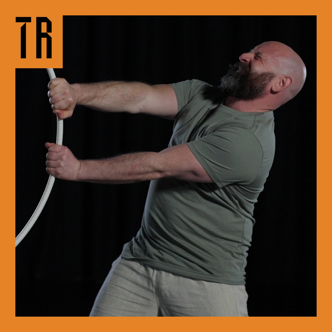 Photo: Tom Chapman A man with a beard looks as though he is pulling a white hoop into the frame.