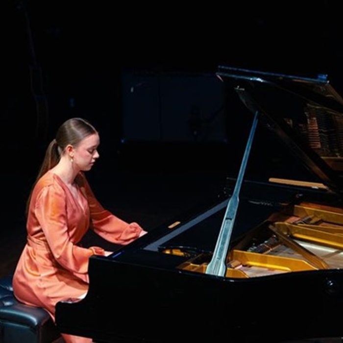 Piano Showcase Female pianist playing grand piano