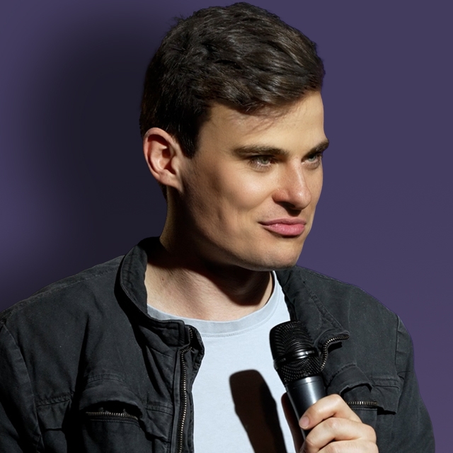 Friendly Jordies A man holding a mic stands against a dark purple background