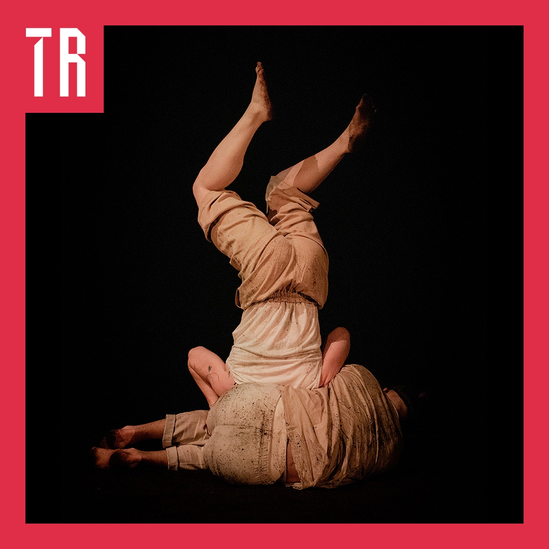 Photo: Rosie Hastie A couple of performers dressed in skin colour clother, pose in an abstract form with their backs to us. We cna not see their faces