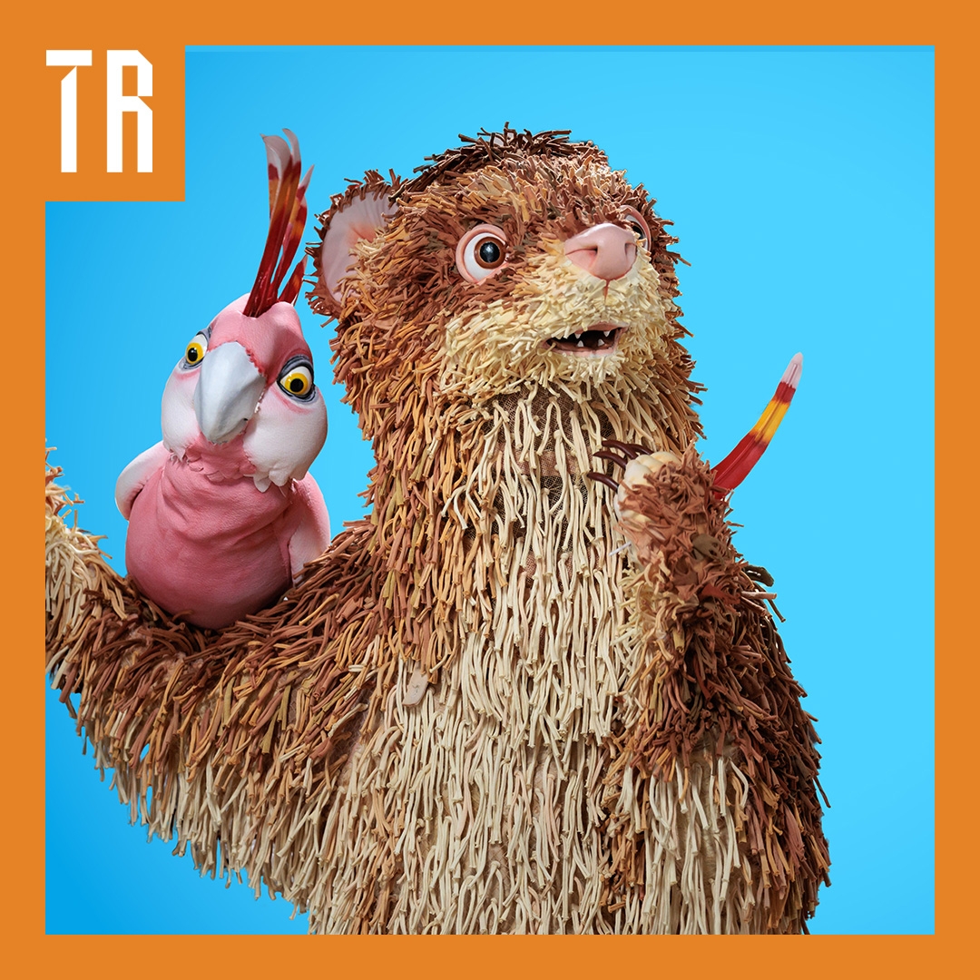 A puppet ferret and a galah pose against a bright blue background