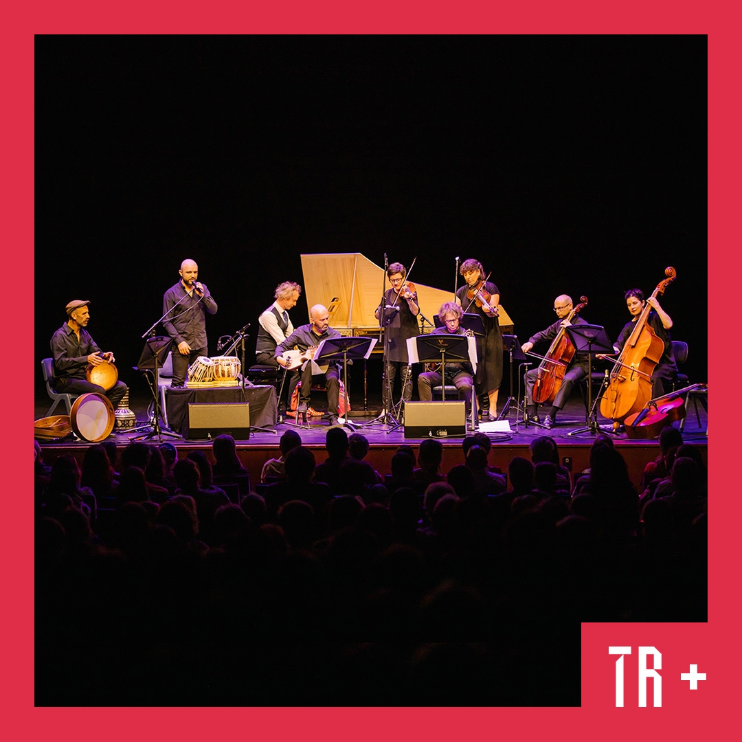 Where Everything is Music hero image 8 musicians on stage, the back ground is black, their string and wood instruments have a warm amber colour in contrast to the black