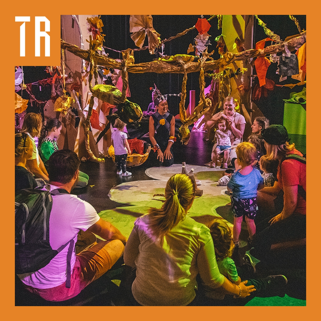 Photo: Jacinta Keefe A group of adults and children sitting in a circle in a play environment