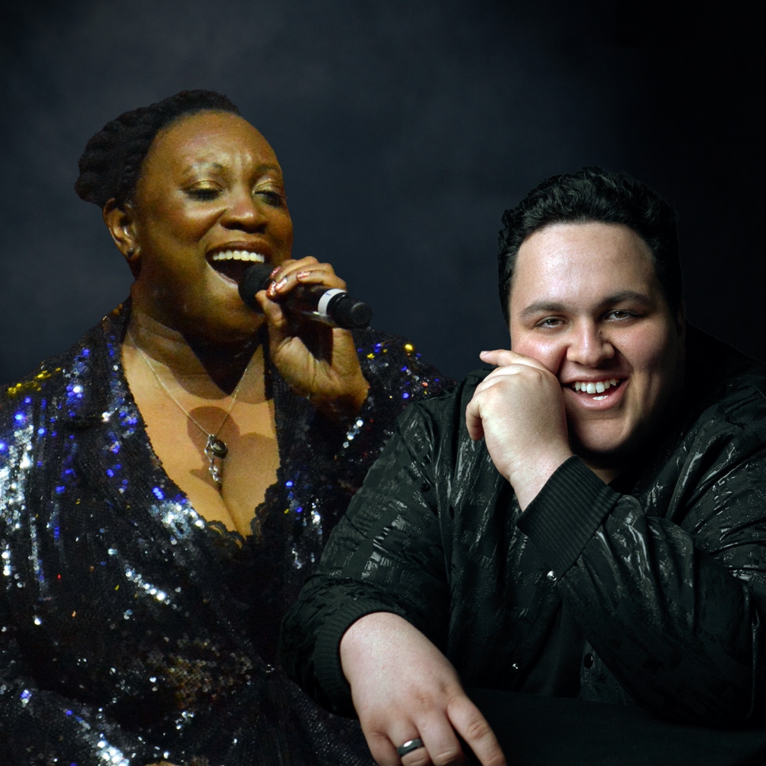 Image: supplied Two performers pose happily against a dark dackground.