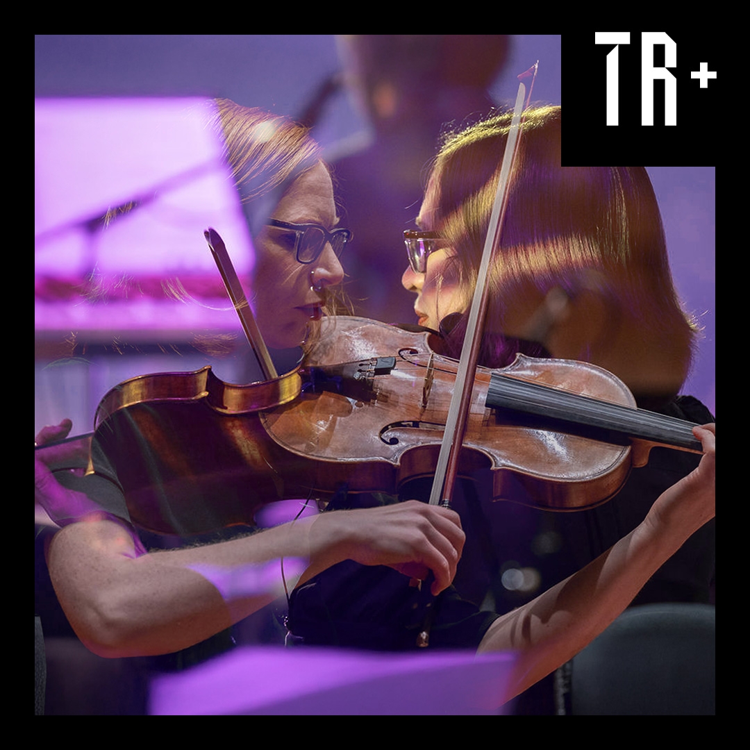 A close up layered image of a woman playing a violing, in the back ground the image is reversed