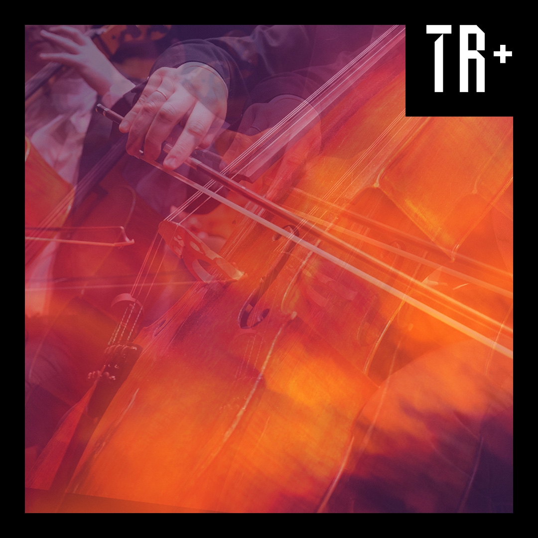 An expressionistic image of golden amber hues, a close up hand draws a bow across a cello