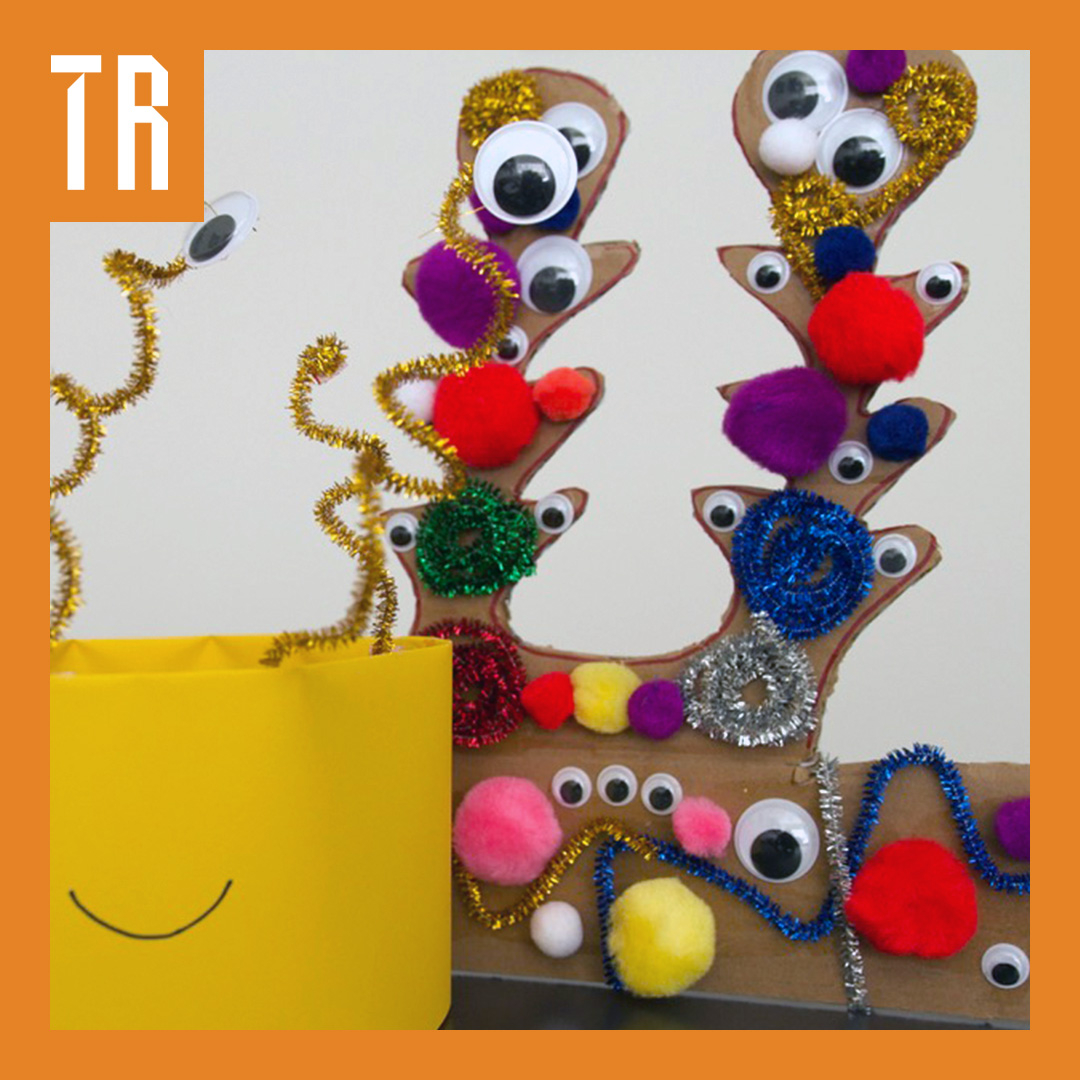 Alien head band craft project with bright coloured pop poms and googely eyes