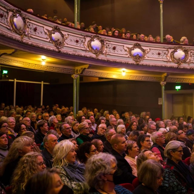 The sta;;s of the Theatre Royal filled with happy audience