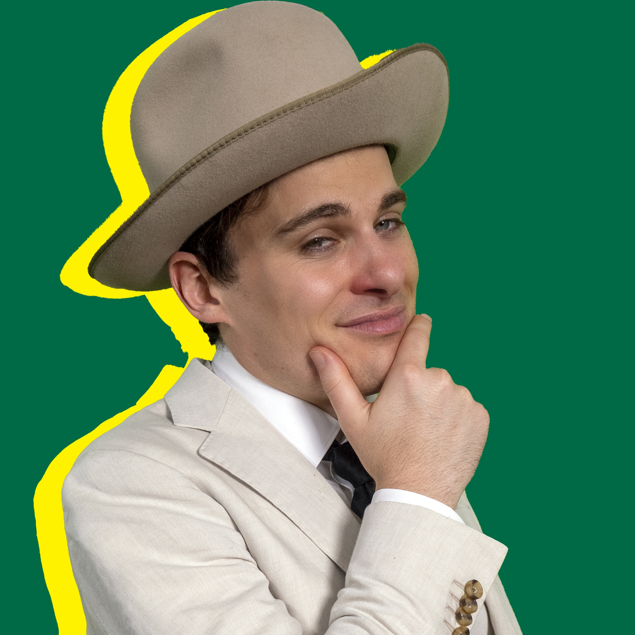 An image of Jordan Shank wearing a beige suit and hat. He has his hand to his face. He is positioned in front of a green background and his shadow is yellow in tone.