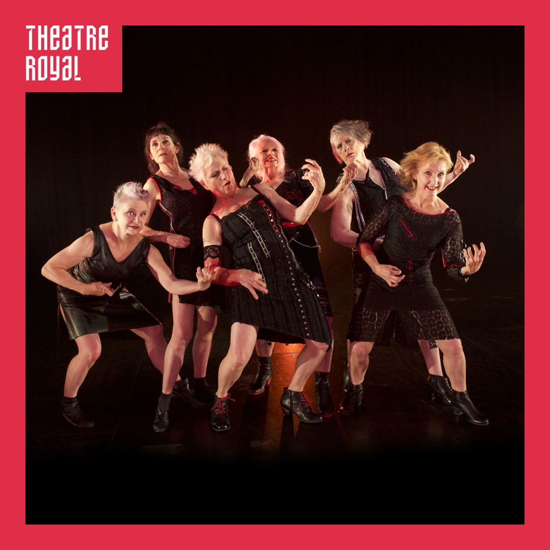 Photo: Tony McKendrick A group of senior women dancers are playing air guitars. They are all dressed in black.