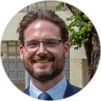 Benjamin Avanzi looks directly to camera and smiles. He wears glasses and has a beard.