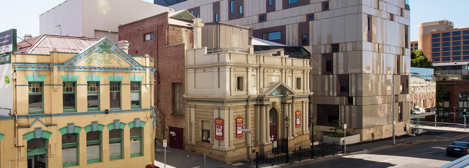 Exterior photo of Theatre Royal and The Hedberg, featuring two older colonial style buildings next to a modern building