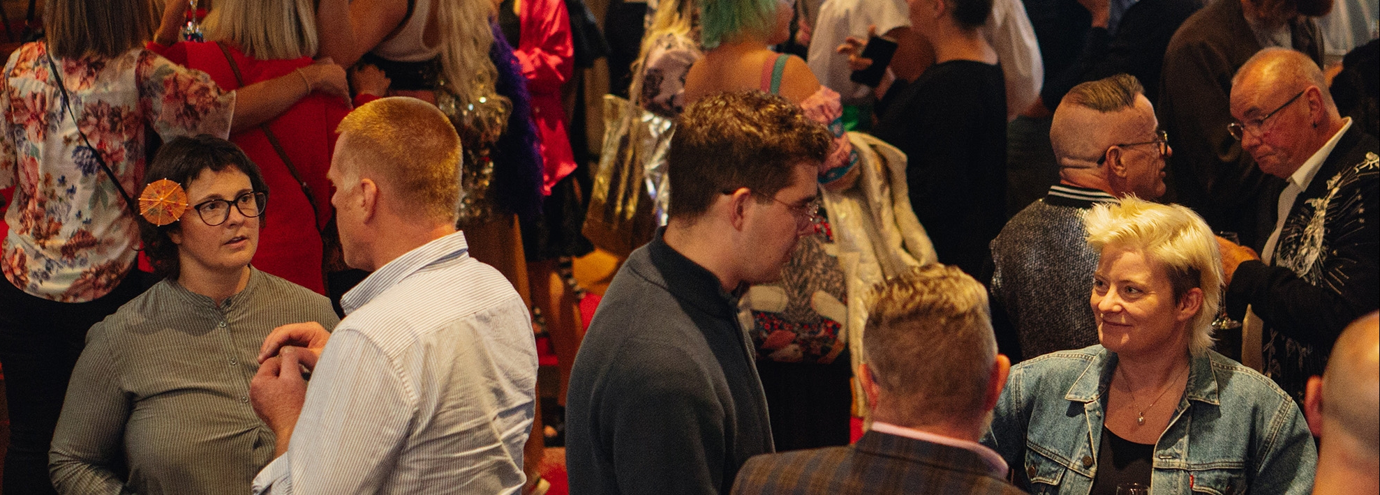 Audience image A gourp of people stand together in the foyers of the Theatre Royal. They are talking and looking happy