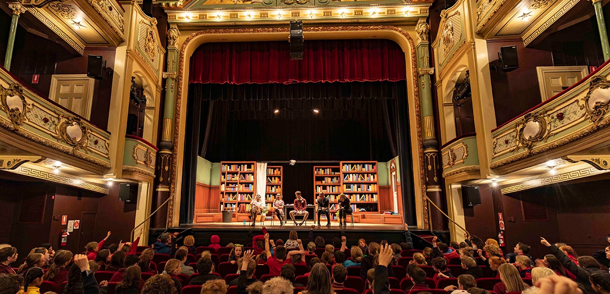The Theatre Royal with an auditorium of school children asking questions of the performenrs on stage