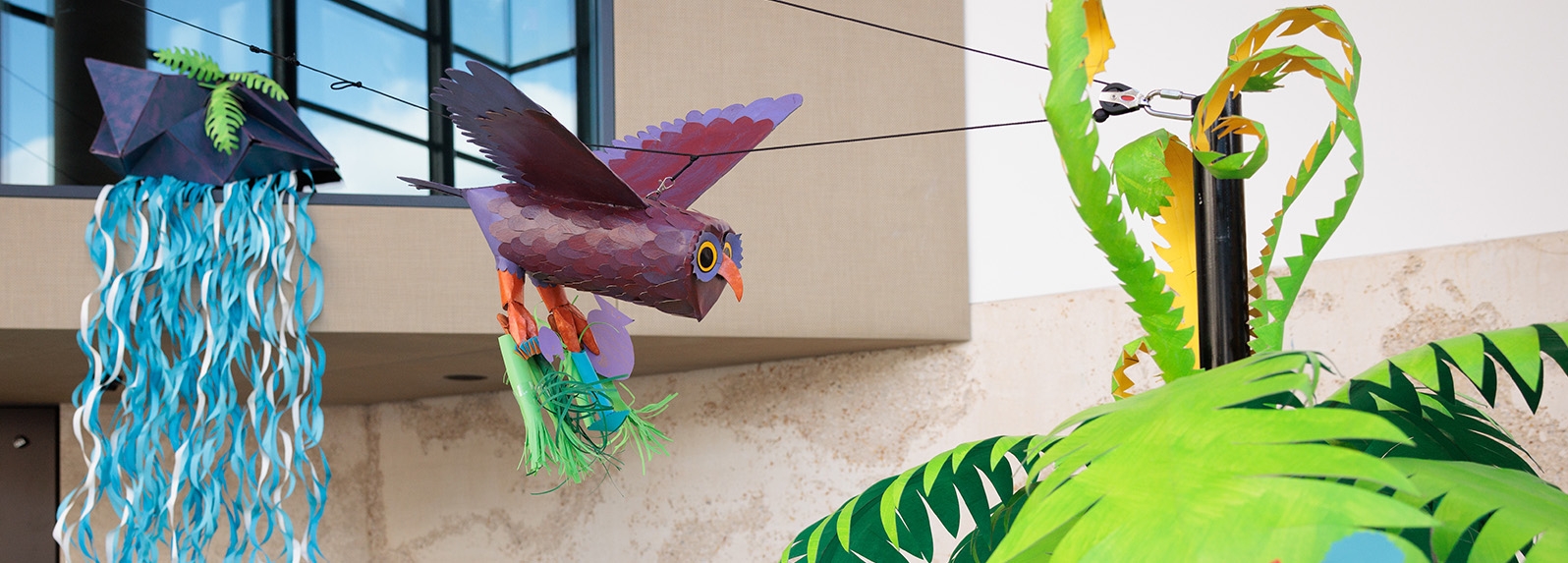 Tactile Tours A paper bird flies through a colourful paper landscape